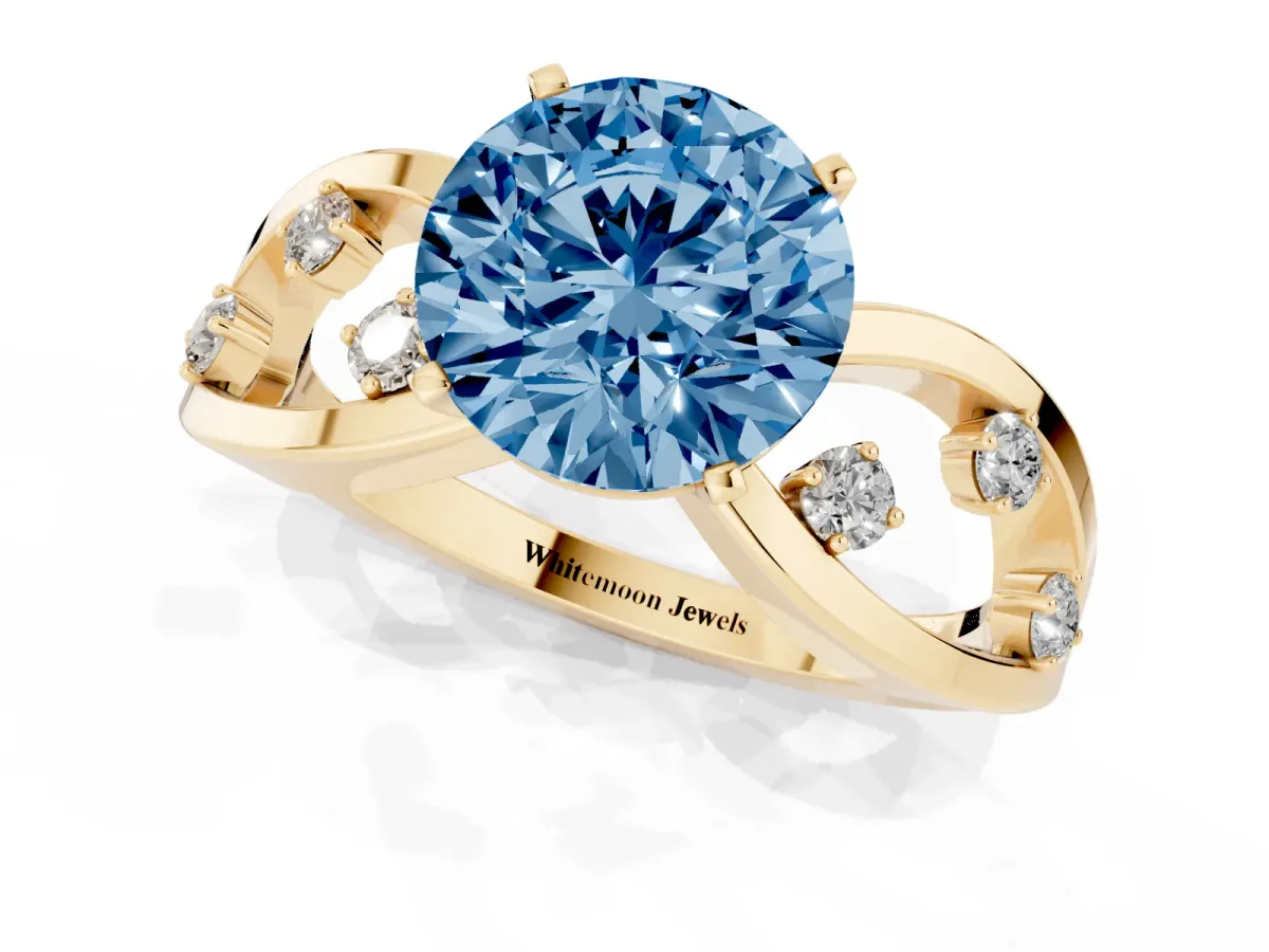 Fancy Blue Round Cut Cut Solitaire Diamond with Side Stones on Criss-Cross Band and Four-Prong Setting Yellow gold