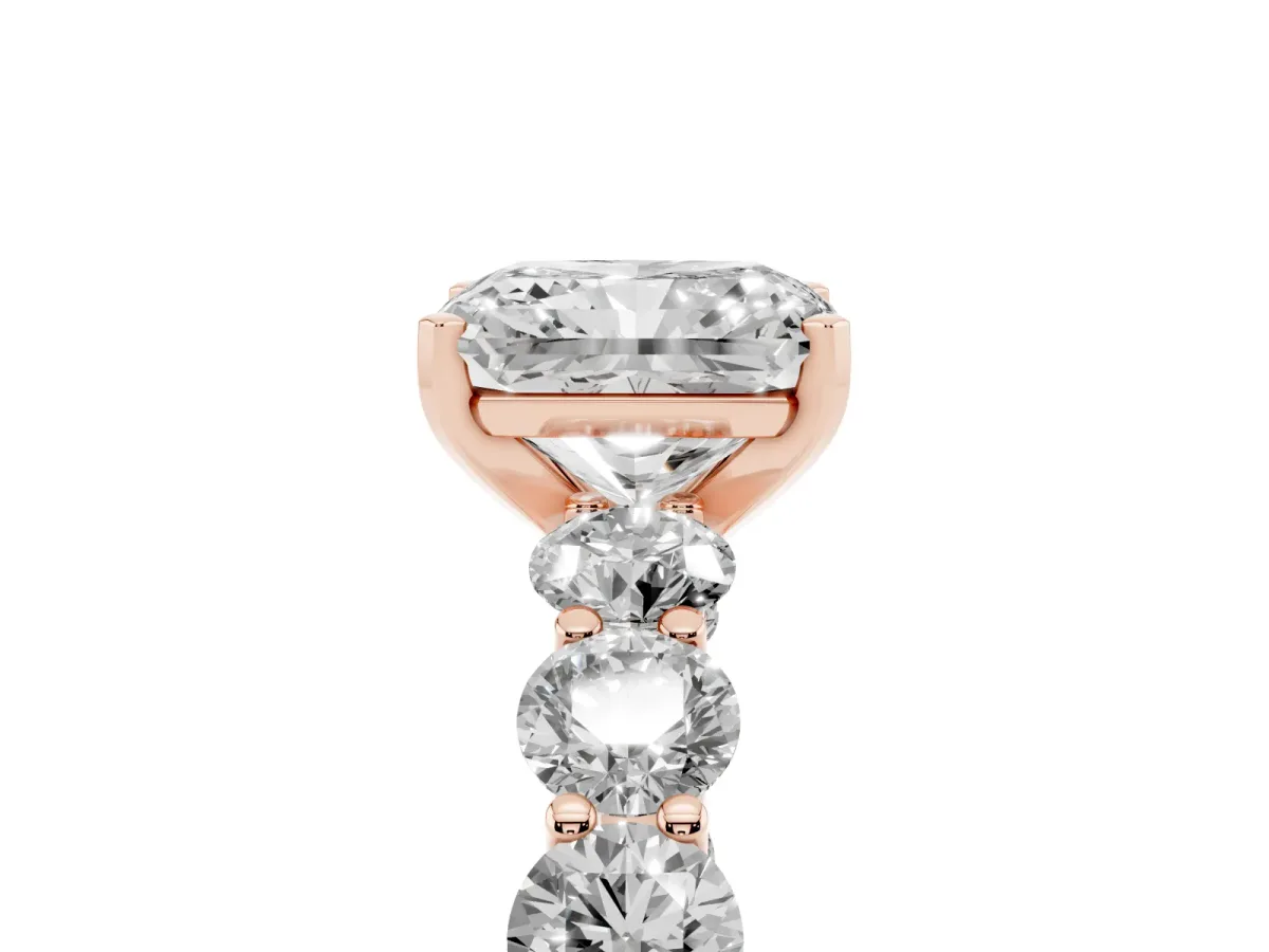 Radiant Cut Diamond Prong Setting with Side Stones on a Pave Band Rose gold