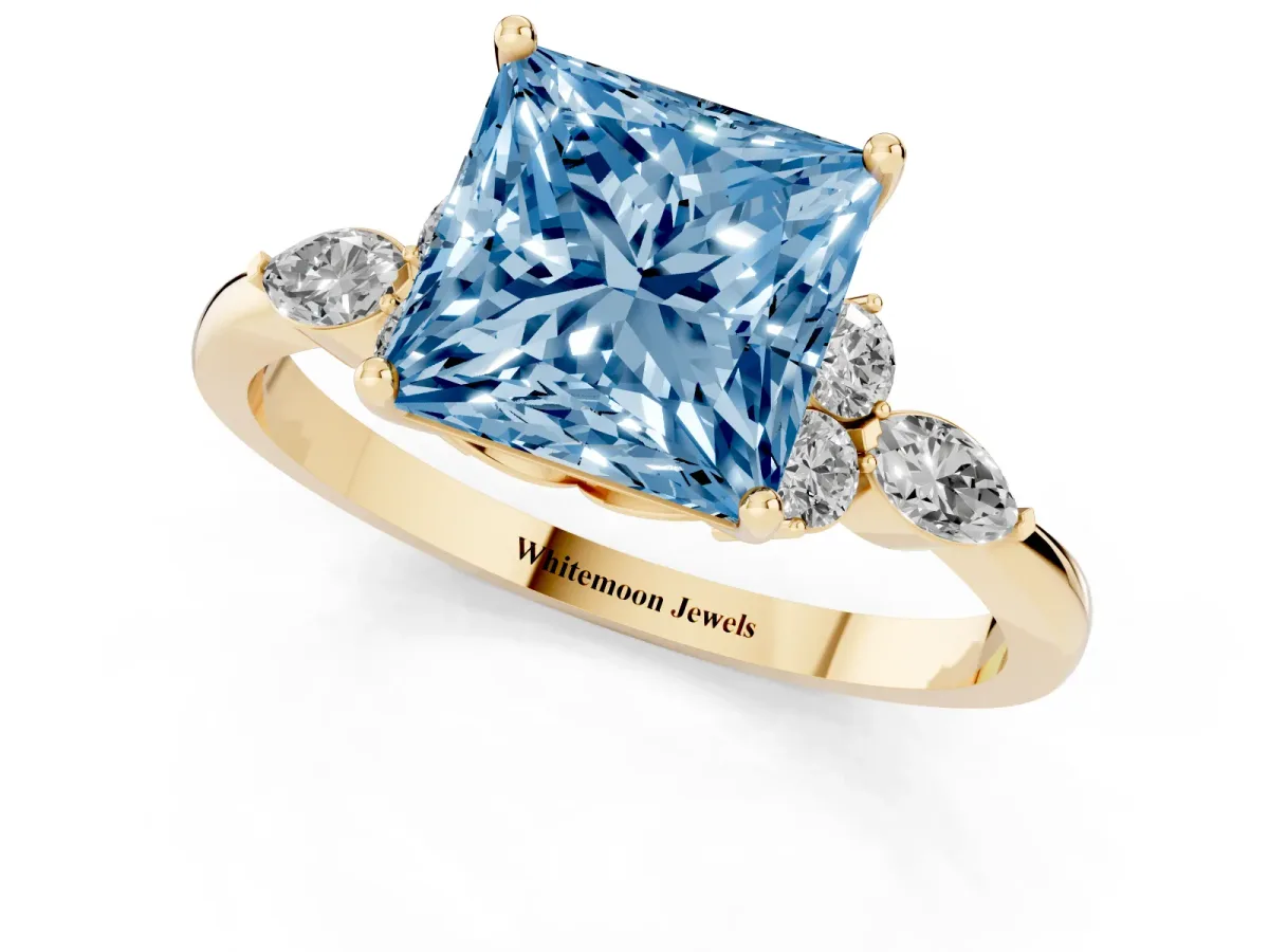 Fancy Blue Princess Cut Brilliant Diamond Solitaire Ring with Pear Side Stones and Four-Prong Setting Yellow gold