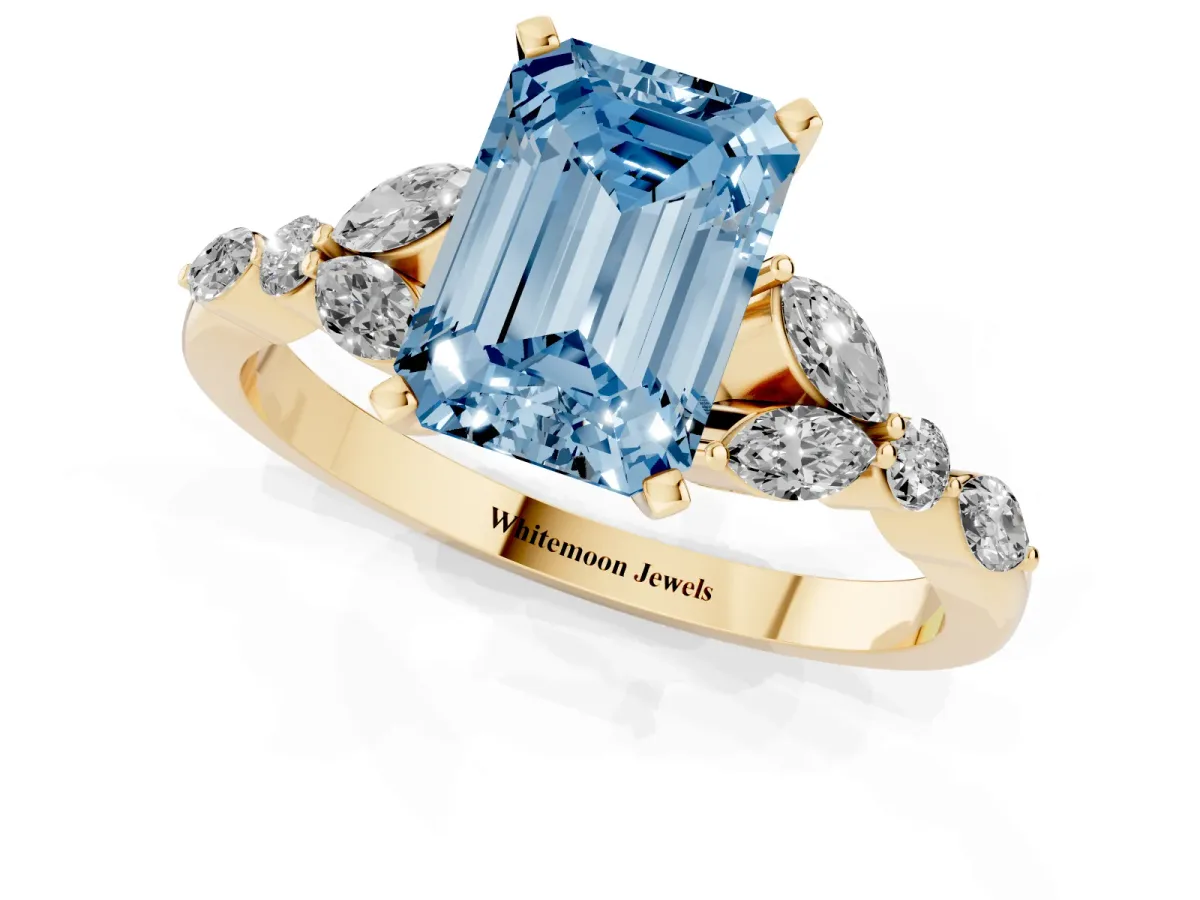 Fancy Blue Emerald Cut Diamond Solitaire Ring with Side Stones and Four-Prong Setting Yellow gold