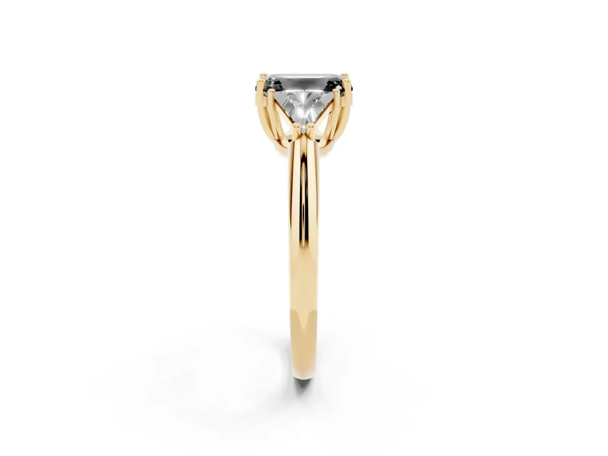Fancy Black Three-Stone Emerald Cut Diamond Engagement Ring with Trillion Side Stones and Prong Setting Yellow gold