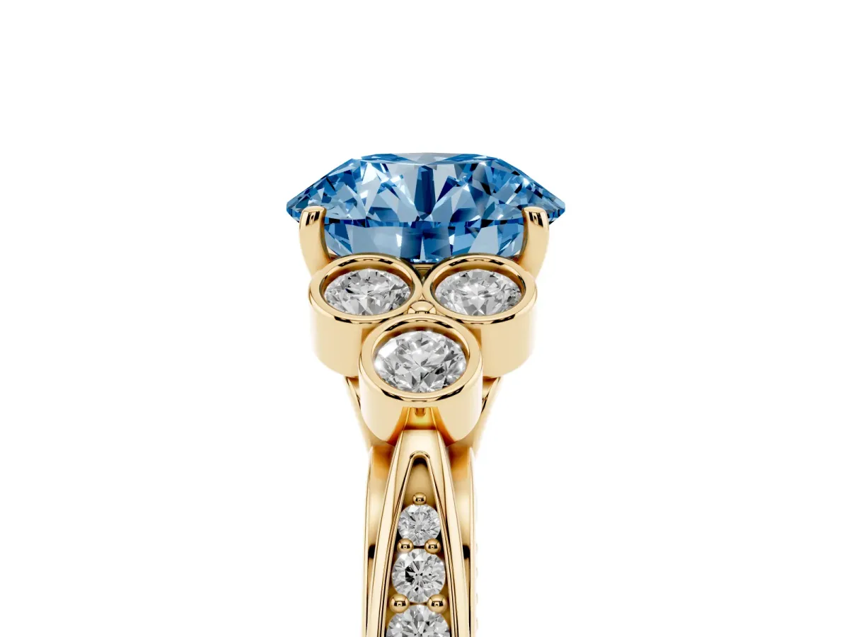 Fancy Blue Round Cut Cut Diamond Engagement Ring with Bezel Set Round Side Stones and Prong Setting Yellow gold