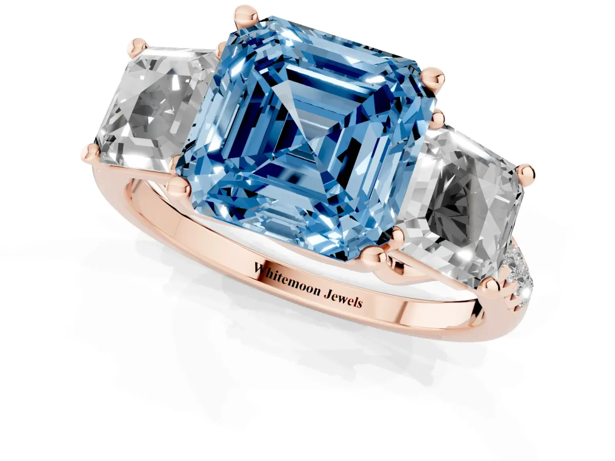 Fancy Blue Three-Stone Asscher Cut Diamond Ring with Round Pavé Band and Prong Setting Rose gold