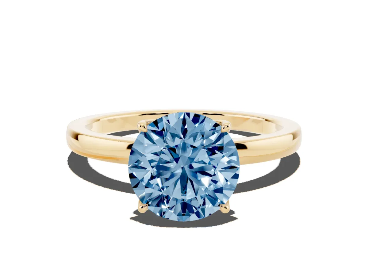 Fancy Blue Round Cut Diamond Solitaire Ring with Thin Band and Prong Setting Yellow gold