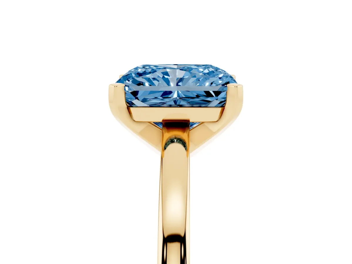 Fancy Blue Radiant Cut Solitaire Diamond Engagement Ring with Four-Prong Setting on a Classic Band Yellow gold