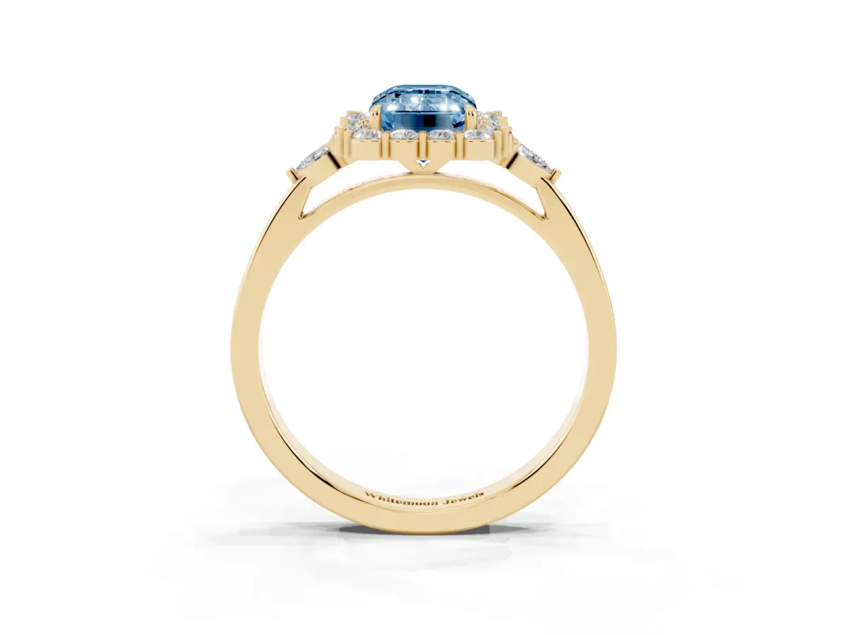 Fancy Blue Emerald Cut Diamond Halo Ring with Pear Side Stones and Prong Setting Yellow gold