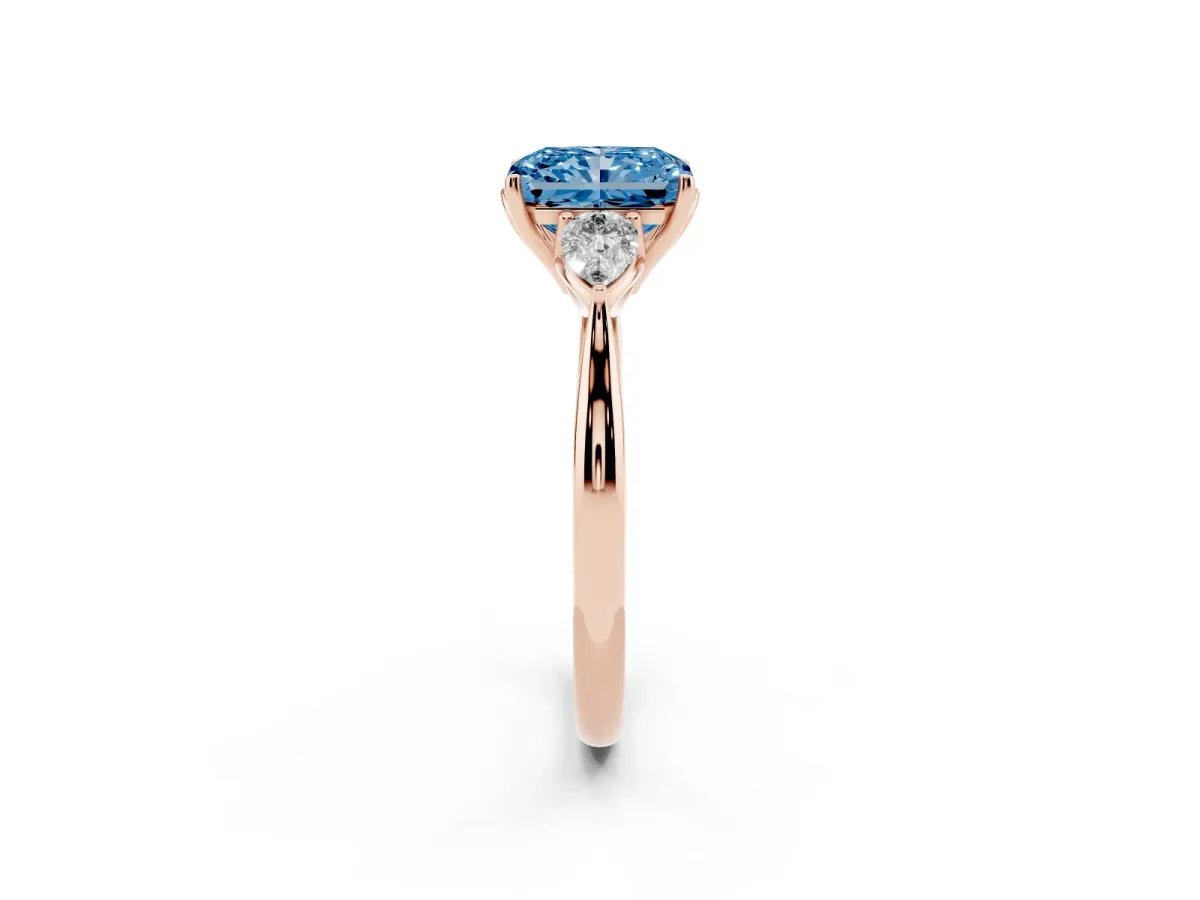 Fancy Blue Three-Stone Radiant Cut Diamond Ring with Pear Side Stones in Four-Prong Setting Rose gold