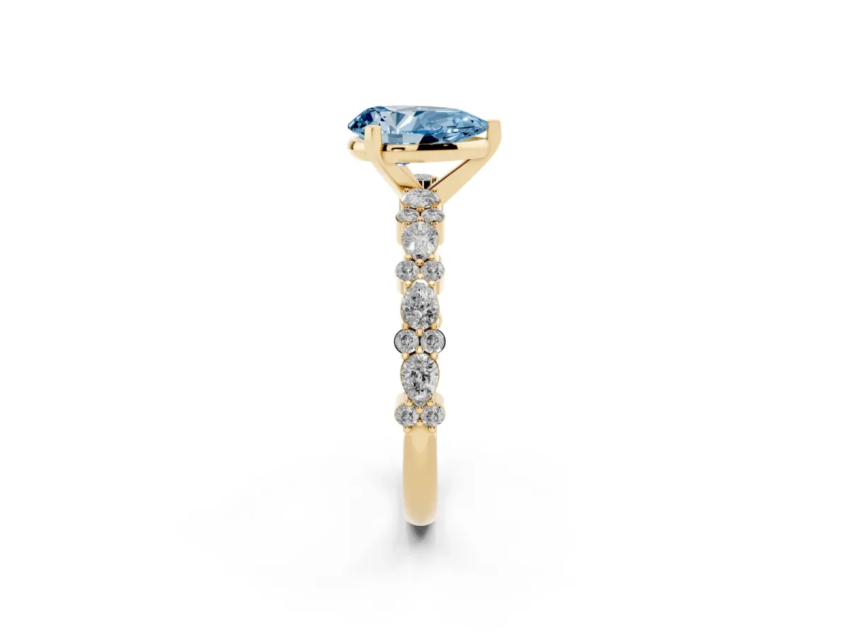 Fancy Blue Pear Cut Diamond Side Stone Solitaire Ring with Round and Four-Prong Setting Yellow gold