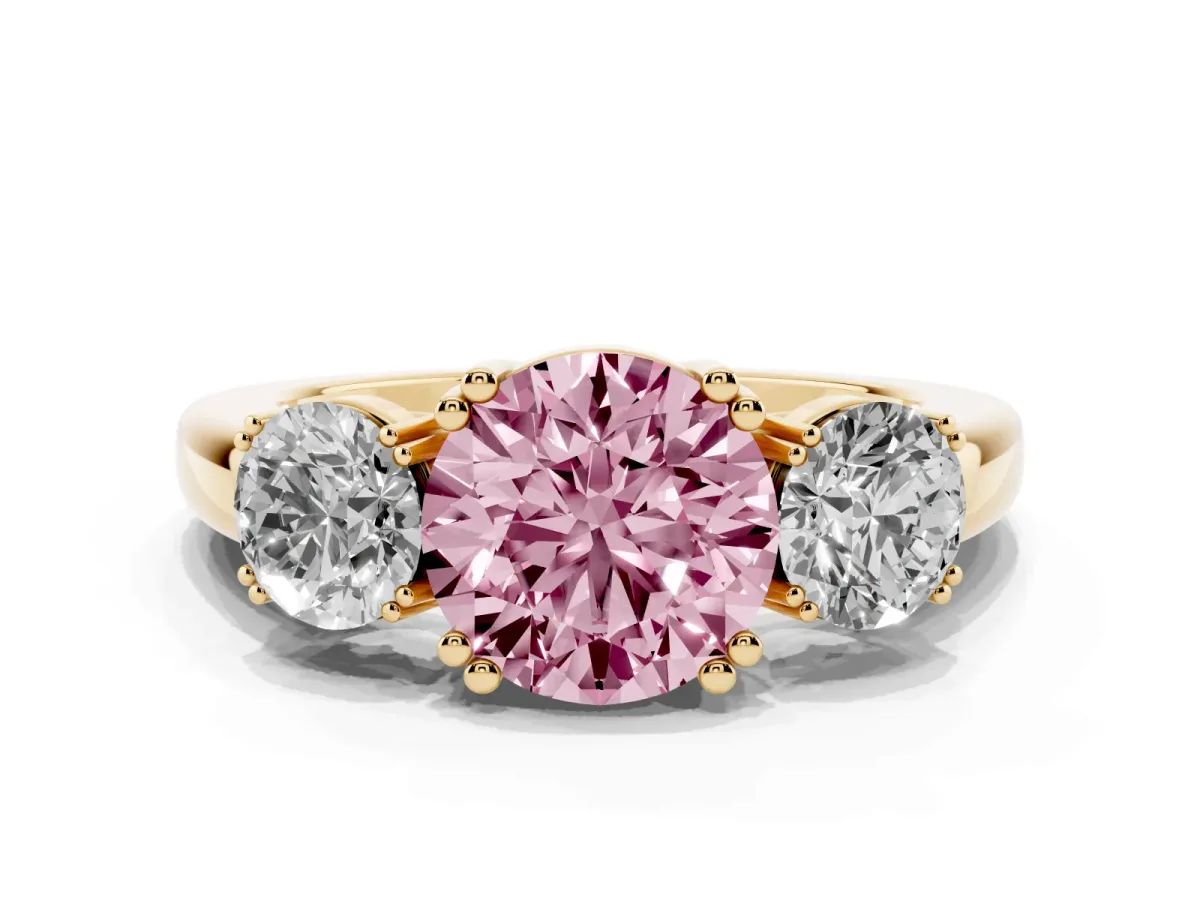 Fancy Pink Three-Stone Round Cut Cut Diamond Ring with Channel Set Band and Four-Prong Setting Yellow gold