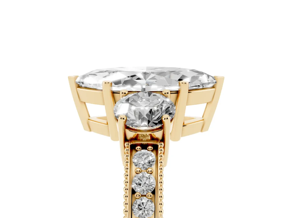 Marquise Cut Three-Stone Diamond Ring with Pavé Band and Four-Prong Setting Yellow gold