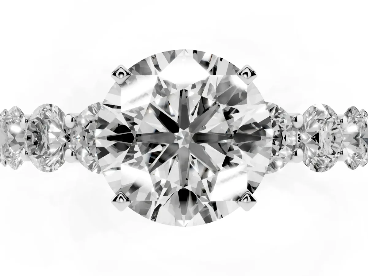 Round Cut Diamond Prong Setting with Side Stones on a Pave Band Silver
