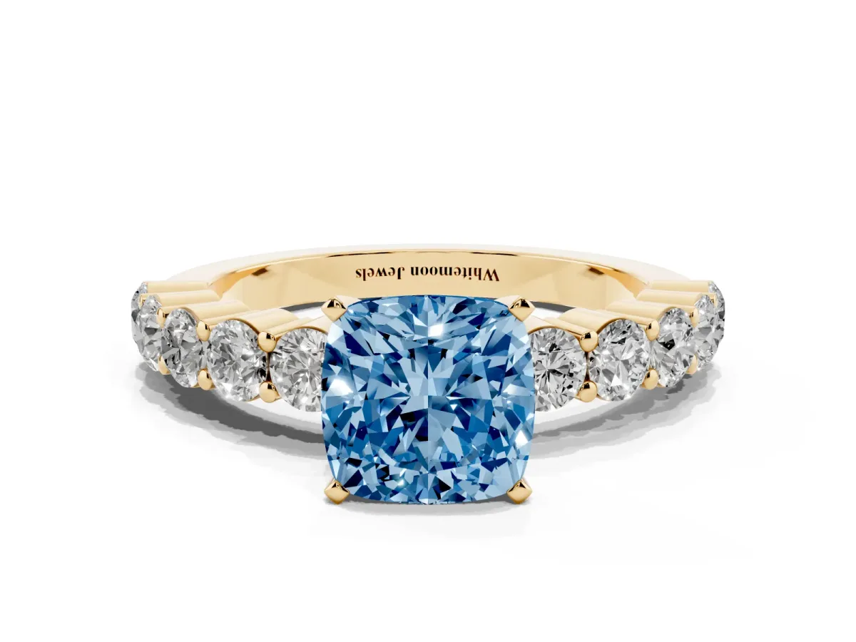 Fancy Blue Cushion Cut Diamond Solitaire Ring with Shared Prong Round Side Stones Yellow gold