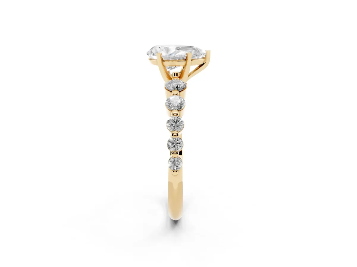 Pear Cut Solitaire Diamond Ring with Pave Band and Four-Prong Setting Yellow gold
