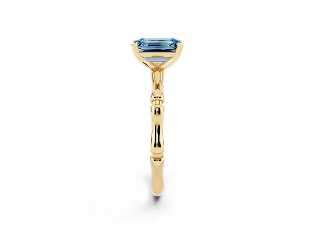 Fancy Blue Emerald Cut Solitaire Diamond Ring with Bamboo Band and Four-Prong Setting Yellow gold