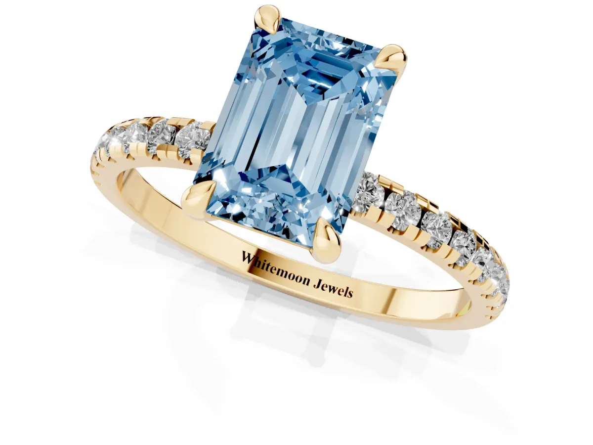 Fancy Blue Emerald Cut Diamond Brilliant Solitaire Ring with Pavé Band and Four-Prong Setting Yellow gold