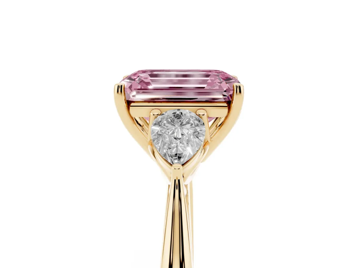 Fancy Pink Three-Stone Emerald Cut Diamond Ring with Pear Side Stones in Four-Prong Setting Yellow gold
