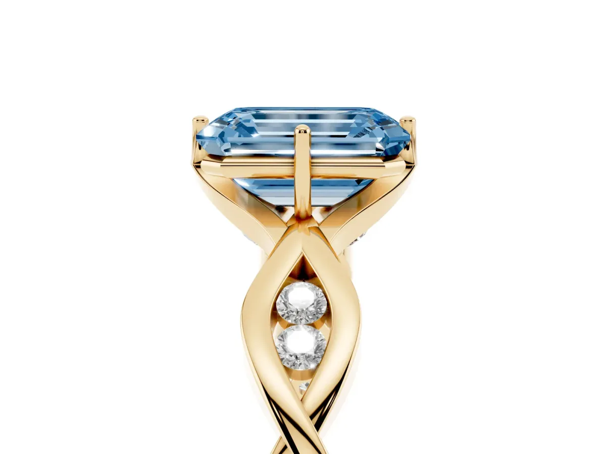 Fancy Blue Emerald Cut Solitaire Twist Band with Leaf Prong Setting Yellow gold