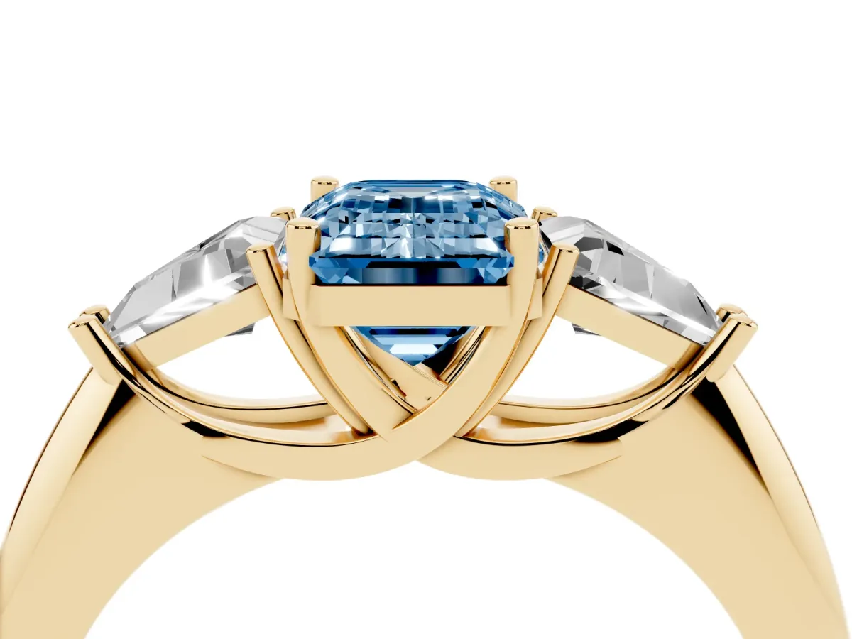 Fancy Blue Three-Stone Emerald Cut Diamond Engagement Ring with Trillion Side Stones and Prong Setting Yellow gold