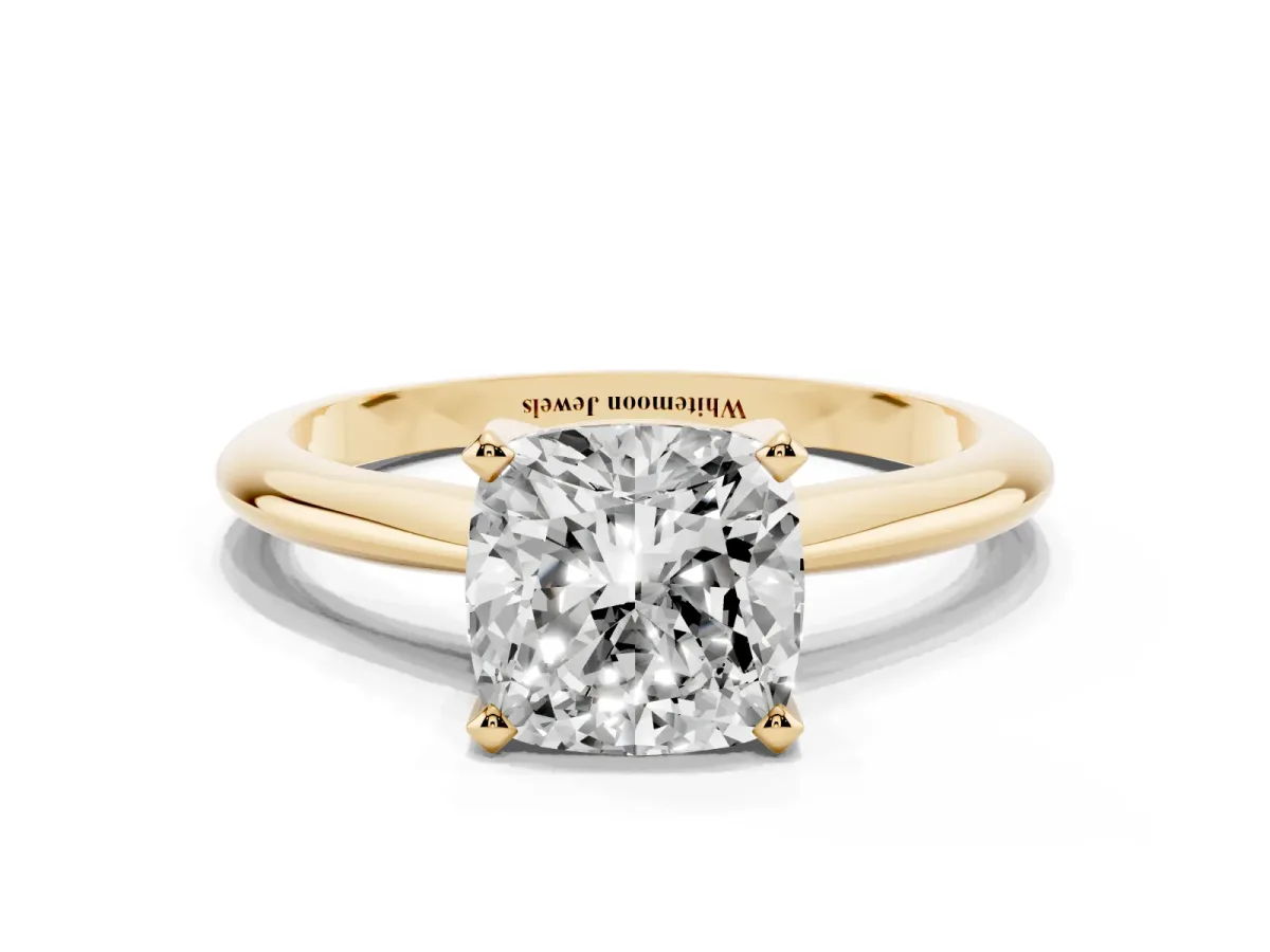 Cushion Cut Cut Solitaire Ring with Four-Prong Setting on a Classic Band Yellow gold