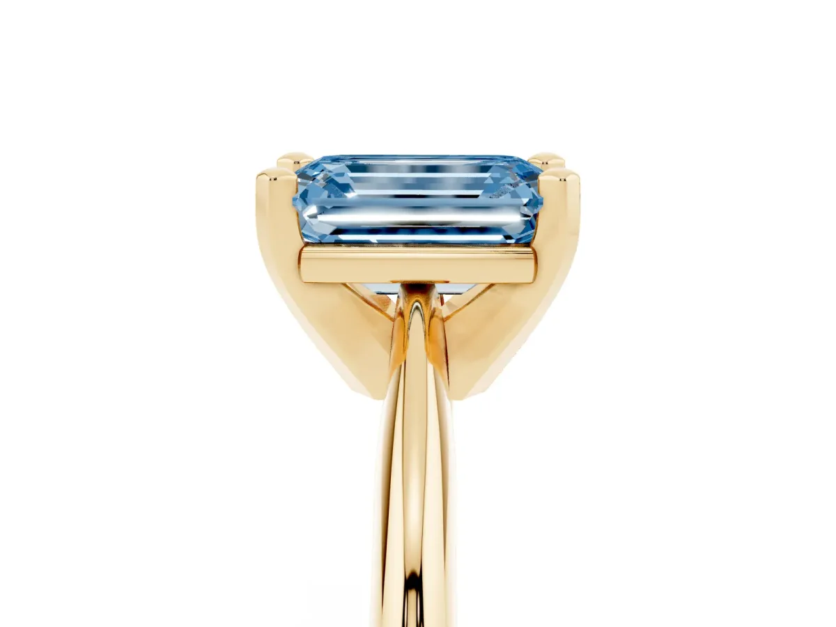 Fancy Blue Emerald Cut Cut Solitaire Ring with Four-Prong Setting on a Classic Band Yellow gold