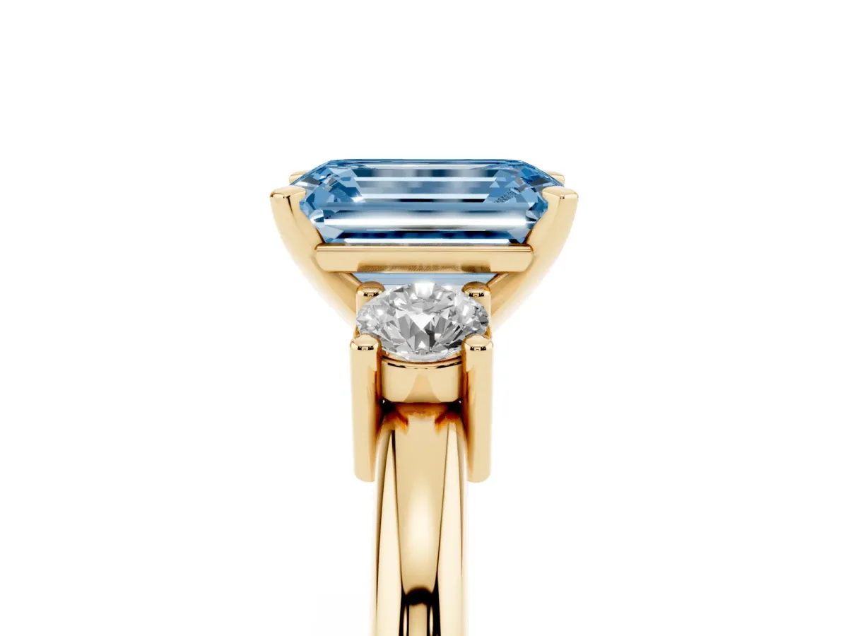 Fancy Blue Three-Stone Emerald Cut Cut Diamond Solitaire with Prong Setting and Classic Band Yellow gold