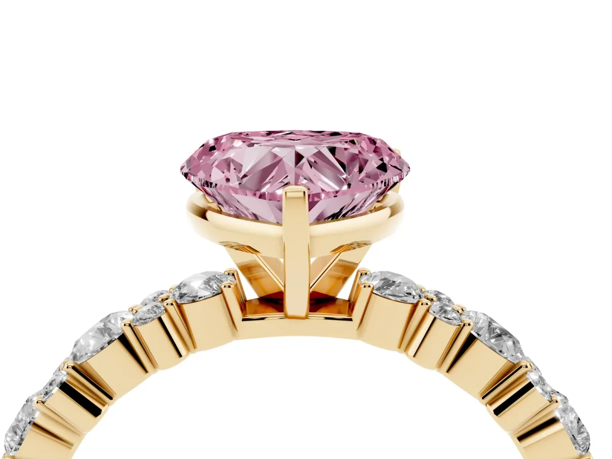 Fancy Pink Heart Cut Diamond Side Stone Solitaire Ring with Round and Four-Prong Setting Yellow gold
