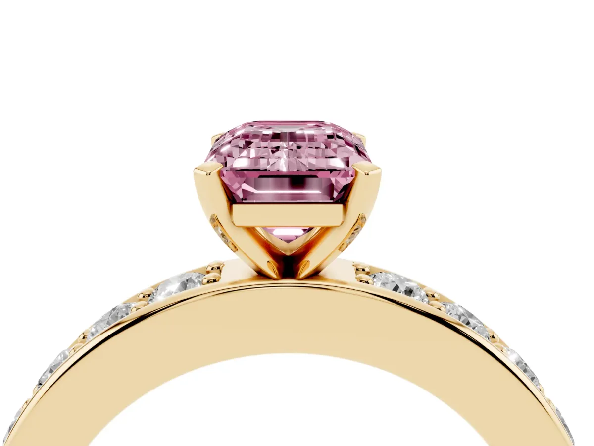 Fancy Pink Emerald Cut Diamond Engagement Ring with Channel Set Round Band and Prong Setting Yellow gold