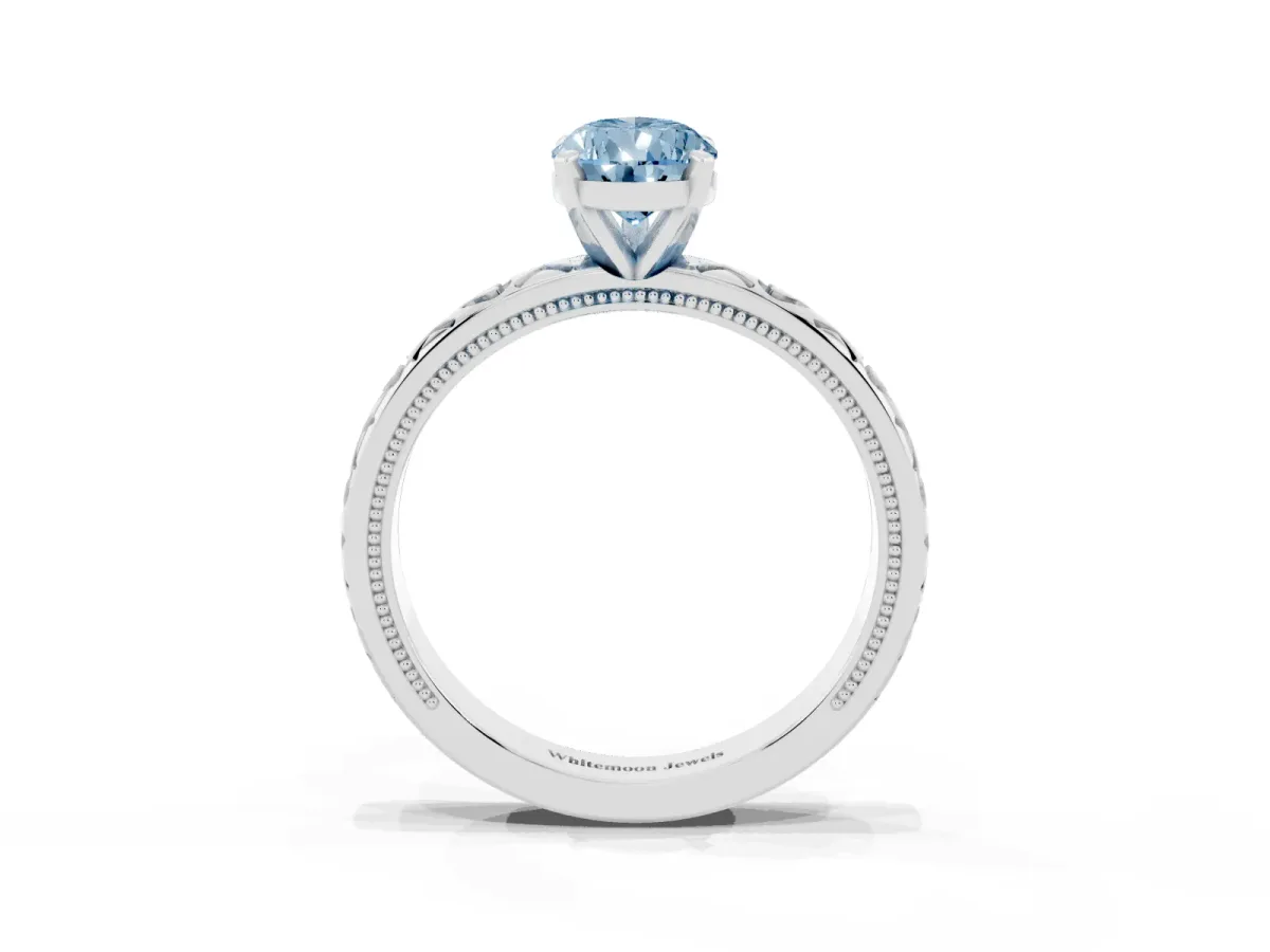 Fancy Blue Pear Cut Solitaire Diamond Engagement Ring with XO Engraved Band and Four-Prong Setting White gold
