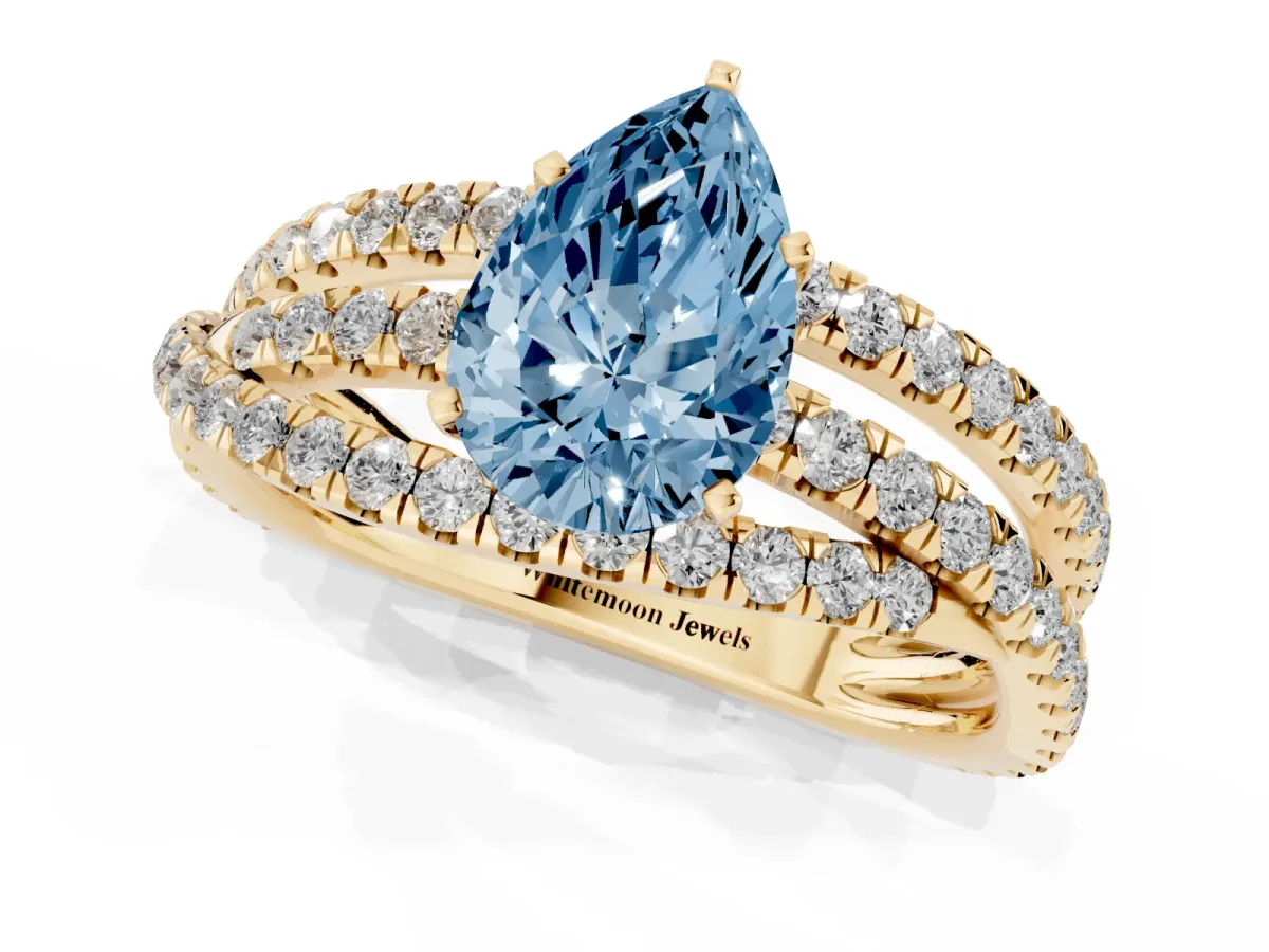 Fancy Blue Pear Cut Solitaire Twist Band with Pavé Setting and Four-Prong Setting Yellow gold