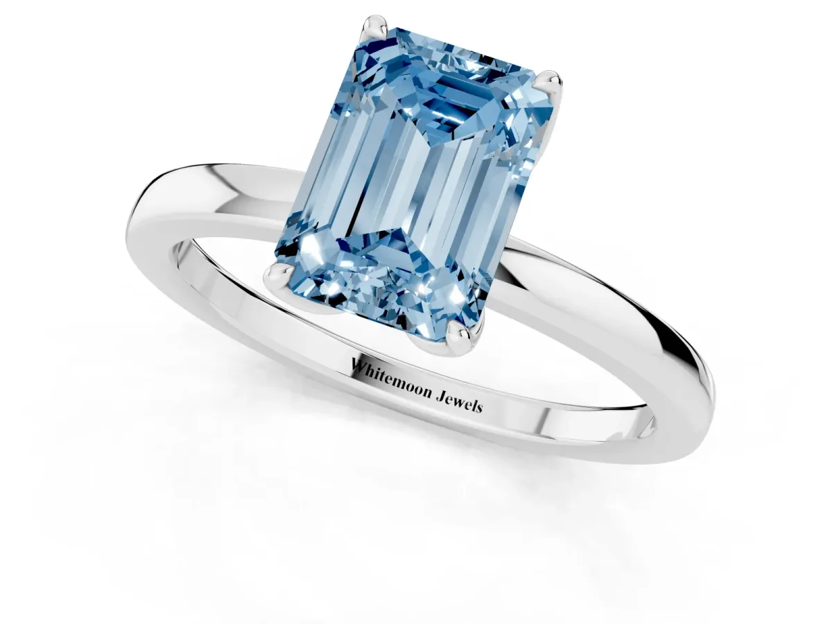 Fancy Blue Emerald Cut Diamond Solitaire Ring with Thin Band and Prong Setting Silver