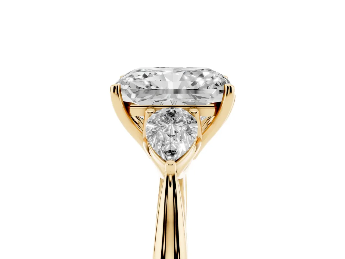 Radiant Cut Diamond Three-Stone Ring with Pear Side Stones and Prong Setting Yellow gold