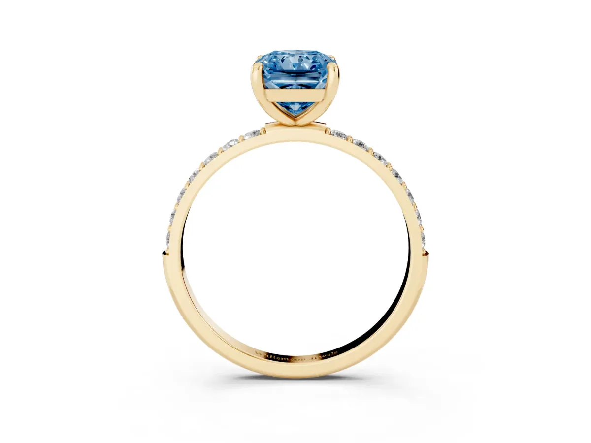 Fancy Blue Radiant Cut Diamond Solitaire Ring with Round Pavé Band and Prong Setting Yellow gold