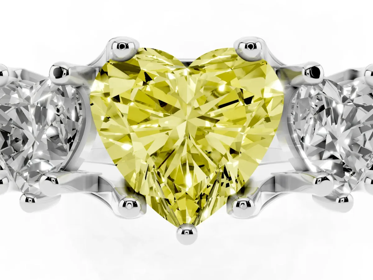 Fancy Yellow Heart Cut Diamond Three-Stone Ring with Channel Set Band and Four-Prong Setting White gold
