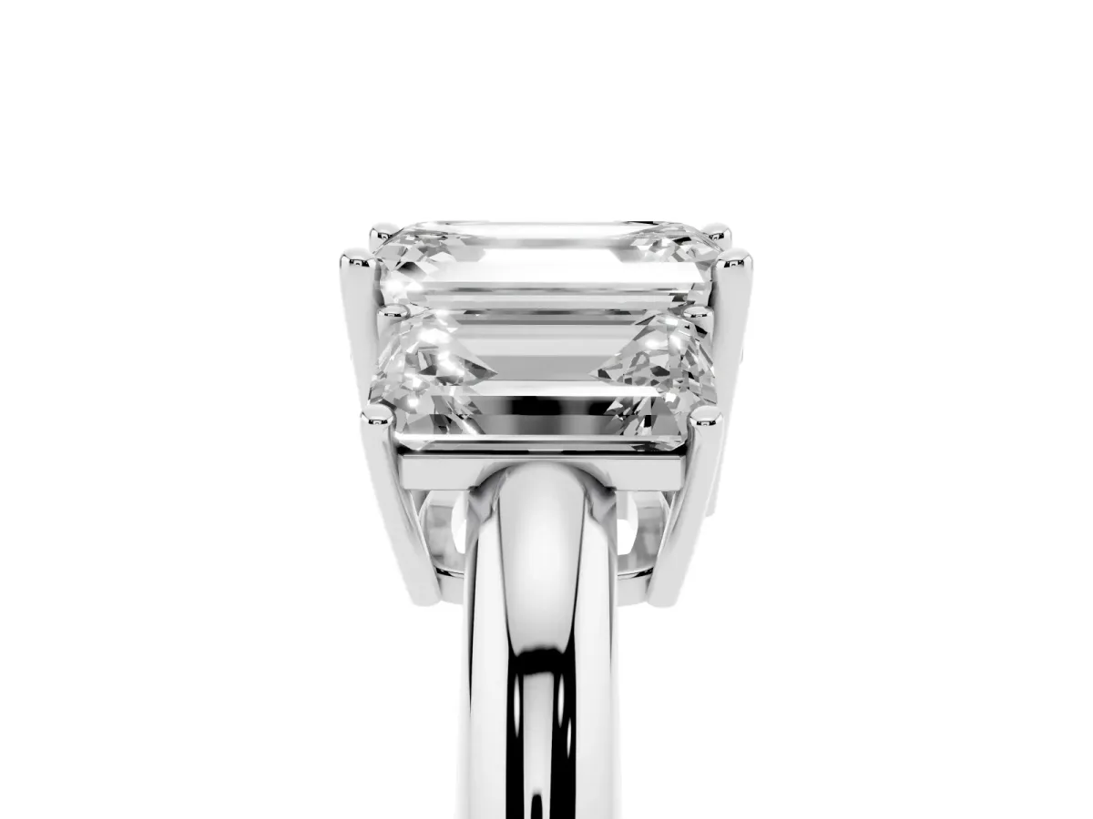 Three-Stone Emerald Cut Cut Diamond Engagement Ring with Prong Setting on a White Gold Band Platinum