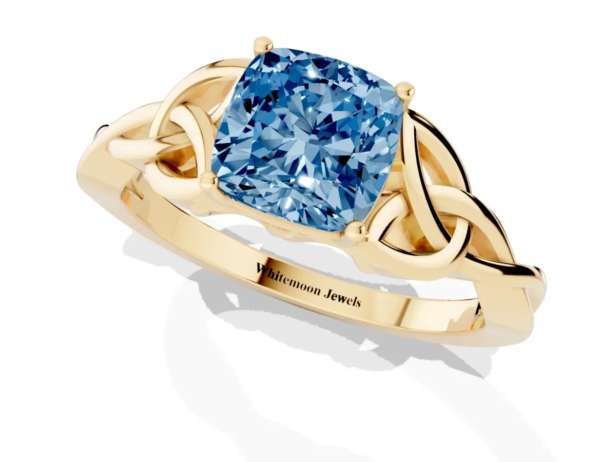 Fancy Blue Cushion Cut Diamond Solitaire Engagement Ring with Celtic Knot Band and Four-Prong Setting Yellow gold