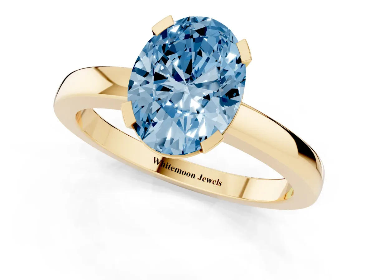 Fancy Blue Oval Cut Cut Solitaire Ring with Four-Prong Setting and Classic Band Yellow gold