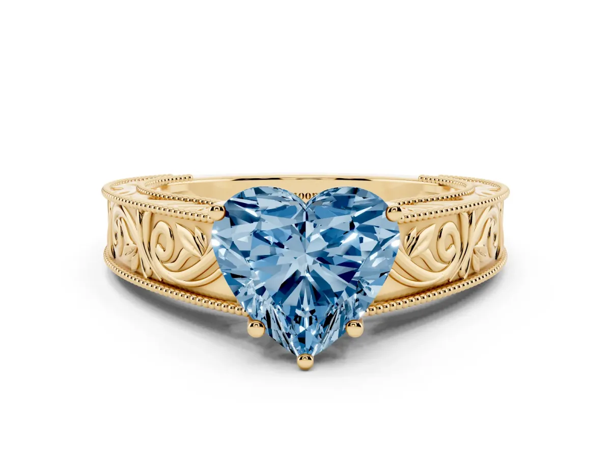 Fancy Blue Heart Cut Diamond Solitaire Ring with Engraved Band and Four-Prong Setting Yellow gold