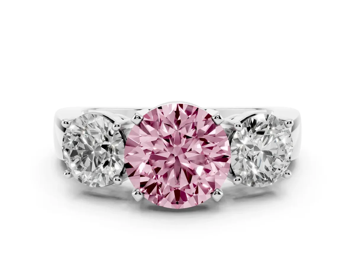 Fancy Pink Three-Stone Round Cut Diamond Ring with Round Side Stones, Classic Band, and Four-Prong Setting Platinum