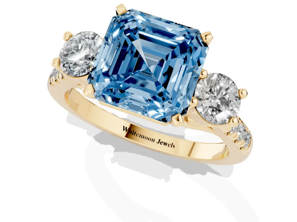 Fancy Blue Three-Stone Asscher Cut Diamond Pavé Band with Four-Prong Setting Yellow gold