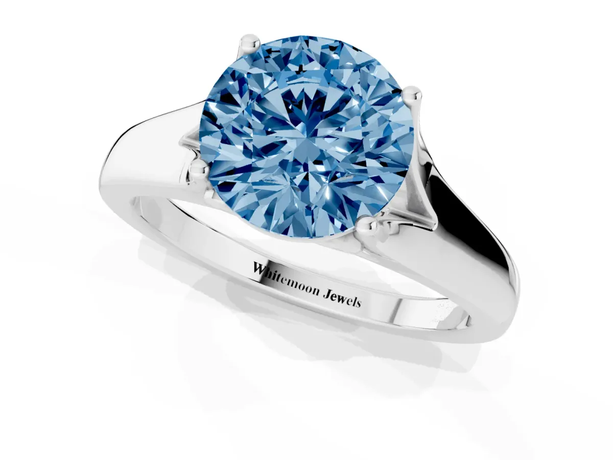 Fancy Blue Round Cut Solitaire Diamond Ring with Cathedral Band and Four-Prong Setting Silver