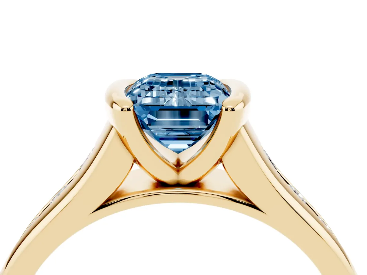 Fancy Blue Emerald Cut Solitaire Bezel-Set Diamond Ring with Channel-Set Band Yellow gold