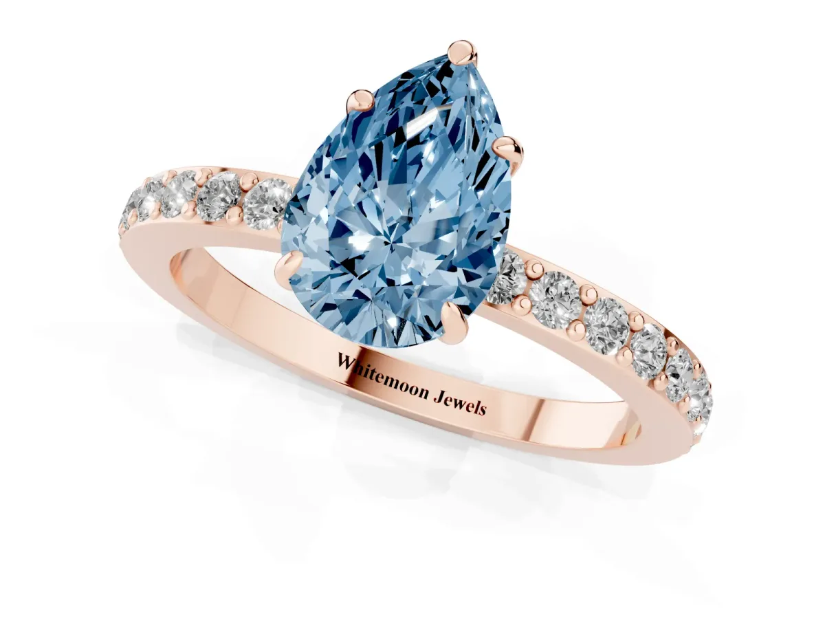 Fancy Blue Pear Cut Diamond Pavé Engagement Ring with Round Accents and Prong Setting Rose gold