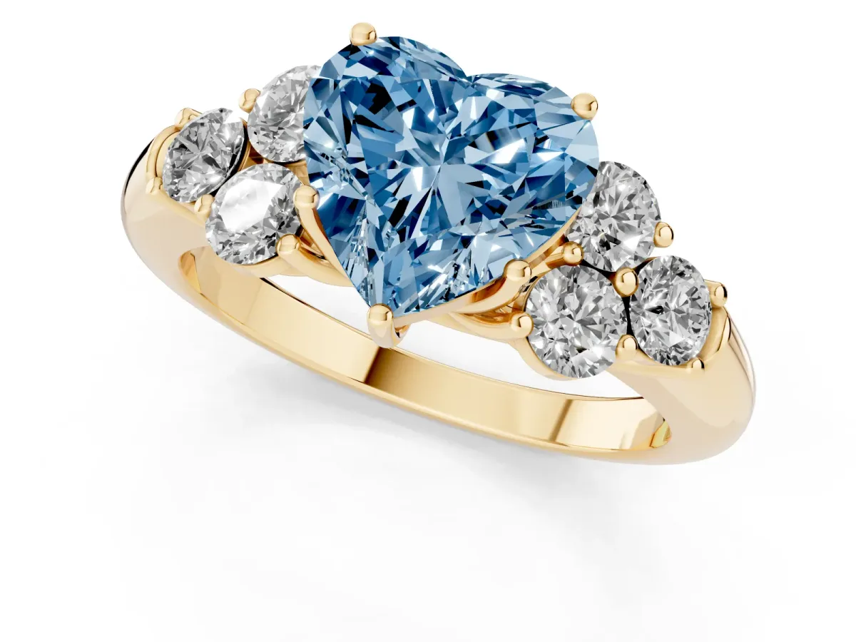 Fancy Blue Heart Cut Cut Diamond Cluster Ring with Round Accent Stones and Prong Setting on a Classic Band Yellow gold
