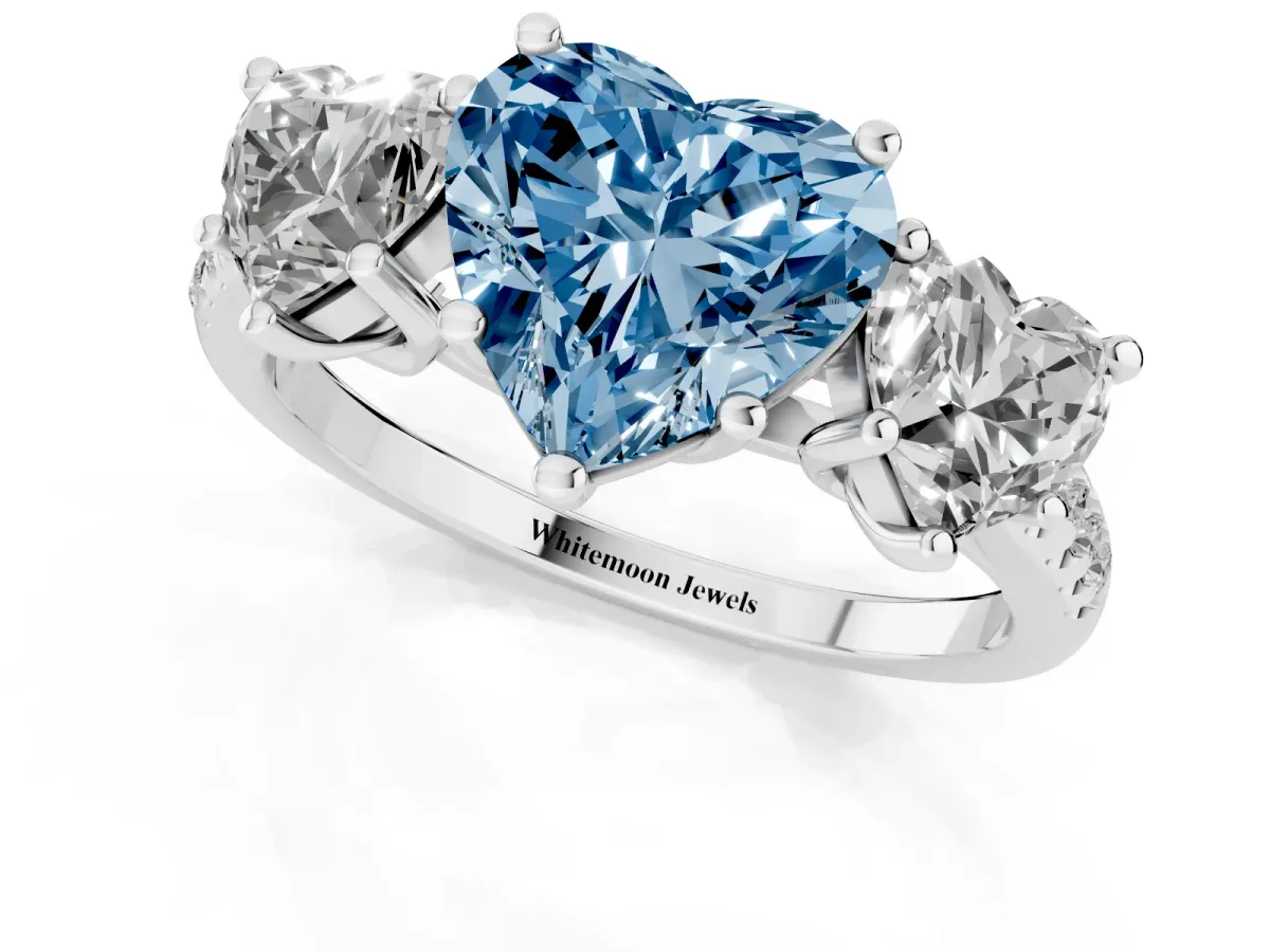 Fancy Blue Three-Stone Heart Cut Diamond Ring with Round Pavé Band and Prong Setting Silver