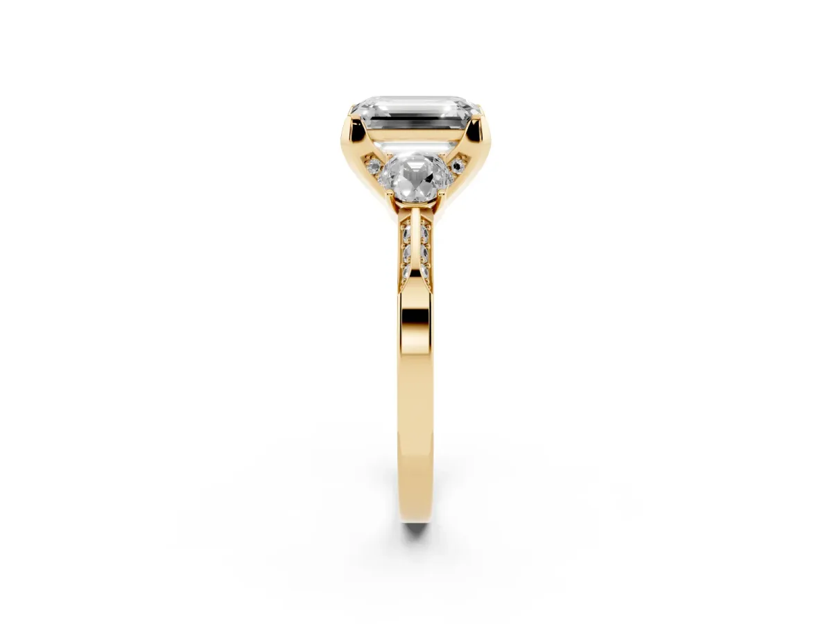Fancy Pink Emerald Cut Brilliant Three-Stone Diamond Ring with Pavé Band and Four-Prong Setting Yellow gold