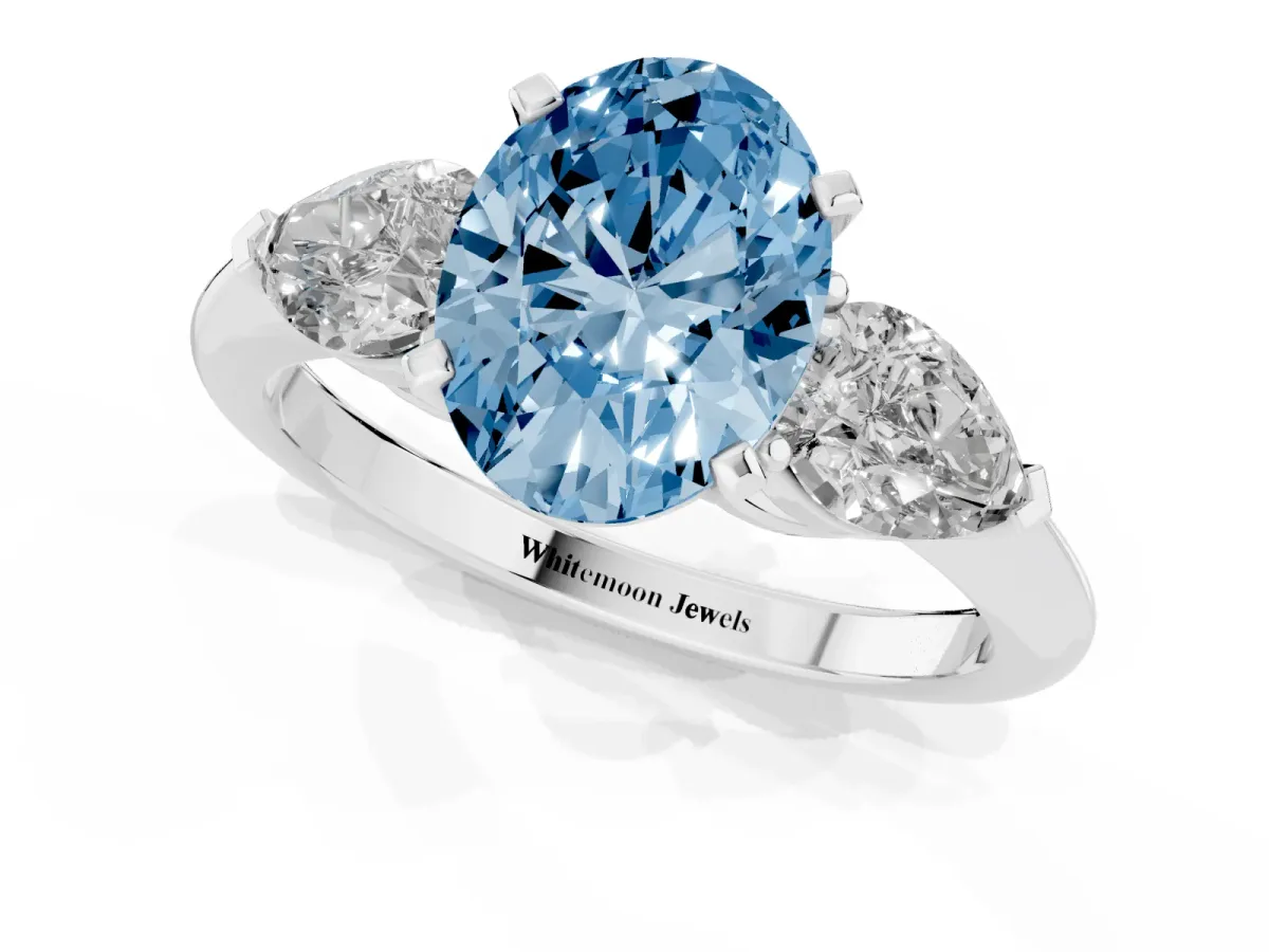 Fancy Blue Three-Stone Oval Cut Diamond Ring with Pear Side Stones and Four-Prong Setting Platinum