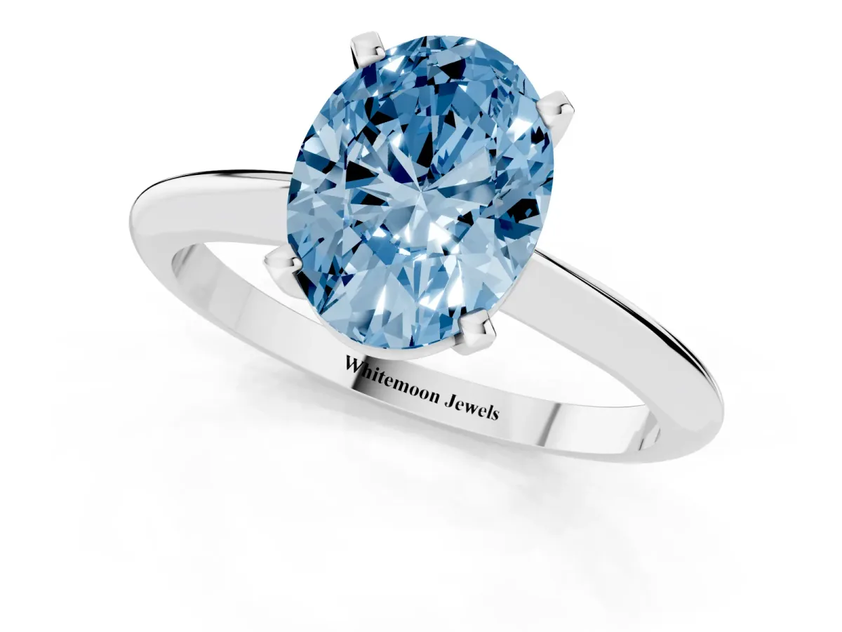 Fancy Blue Oval Cut Cut Solitaire Ring with Four-Prong Setting on a Classic Band Silver