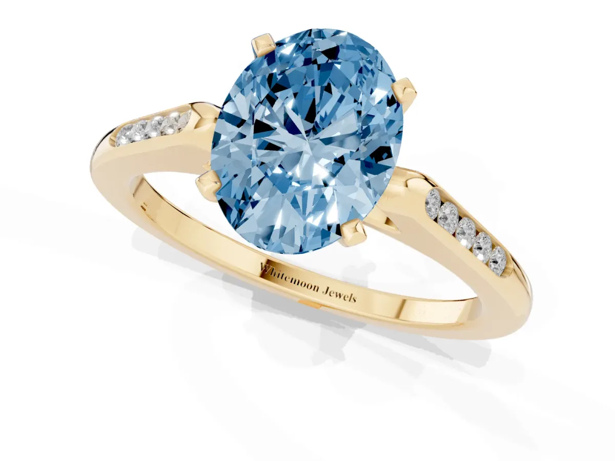 Fancy Blue Oval Cut Diamond Solitaire Ring with Channel Set Round Band and Prong Setting Yellow gold