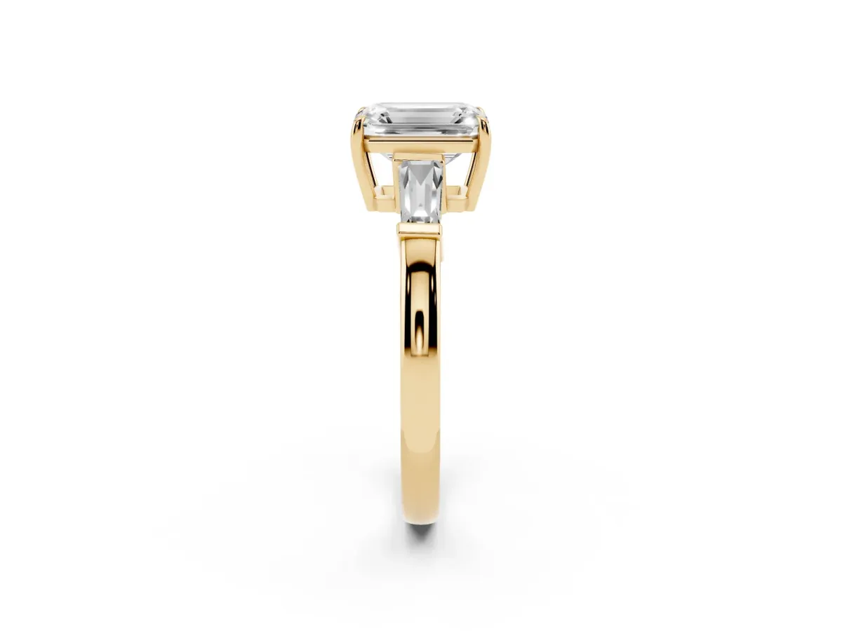 Emerald Cut Diamond Three-Stone Ring with Tapered Baguette Side Stones and Prong Setting Yellow gold
