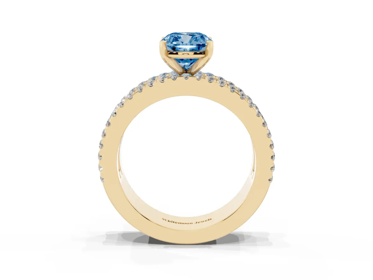 Fancy Blue Cushion Cut Diamond Solitaire Ring with Pavé and Channel Set Band Yellow gold